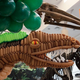 Illustration for article titled 20-foot dinosaur balloon sculpture stands beside its species skeleton
